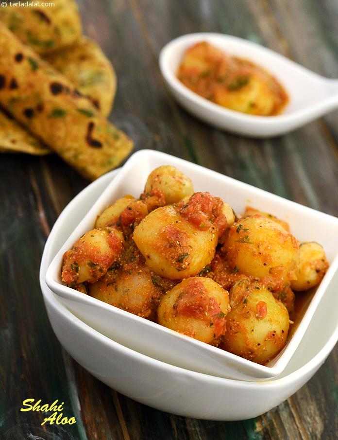 Shahi Aloo, baby potatoes in a delectable semi-dry gravy made with a blend of spicy flavours , tomatoes and curds.Cashews and raisins not only add to the grandeur but also enhances the flavour. 