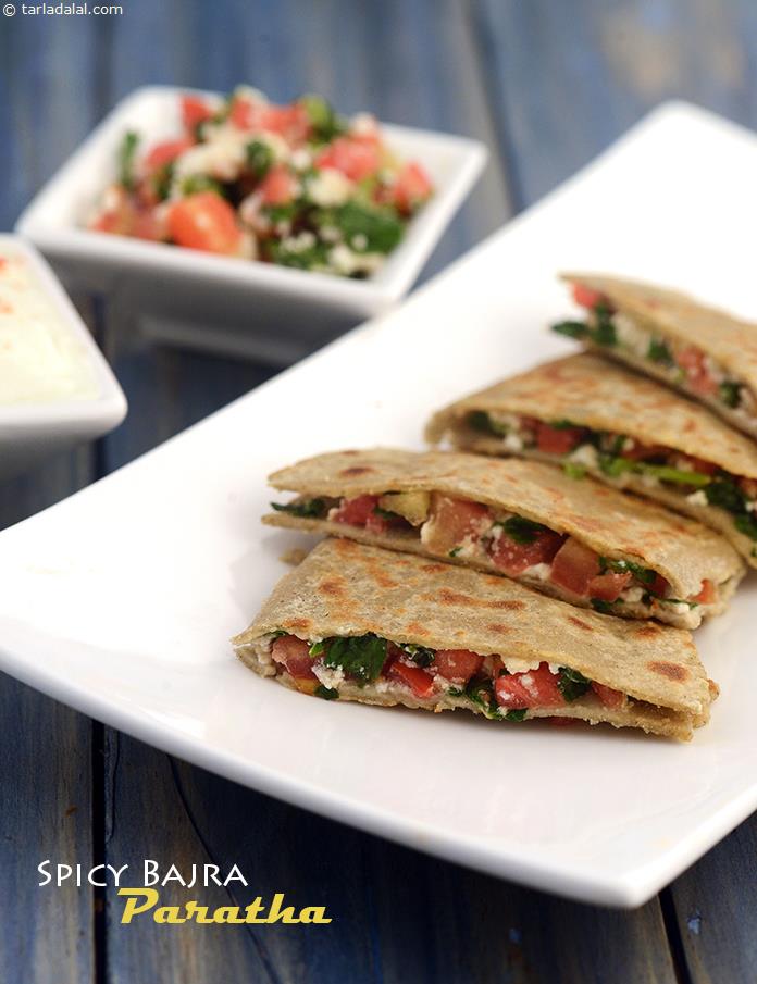 Spicy Bajra Roti stuffed with low-fat paneer, tomatoes and fenugreek leaves make a healthy breakfast recipe.