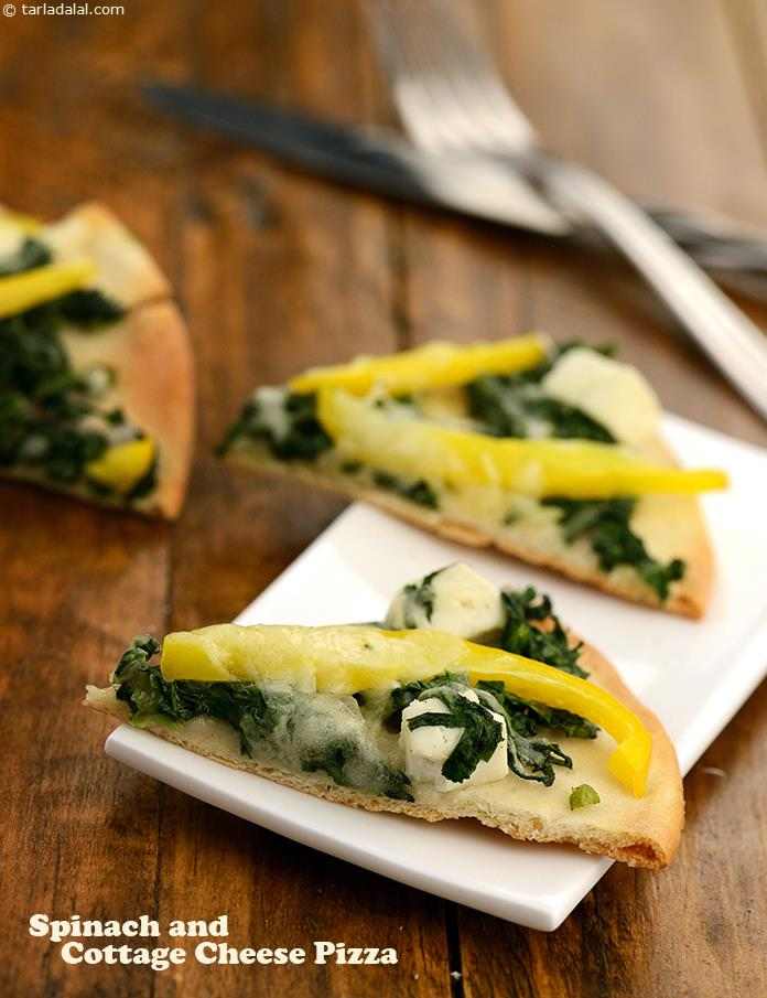 Spinach Pizzas, topped with spinach and paneer and fresh cream, a nice layer of mozzarella cheese. This is baked until the cheese is all hot and gooey.