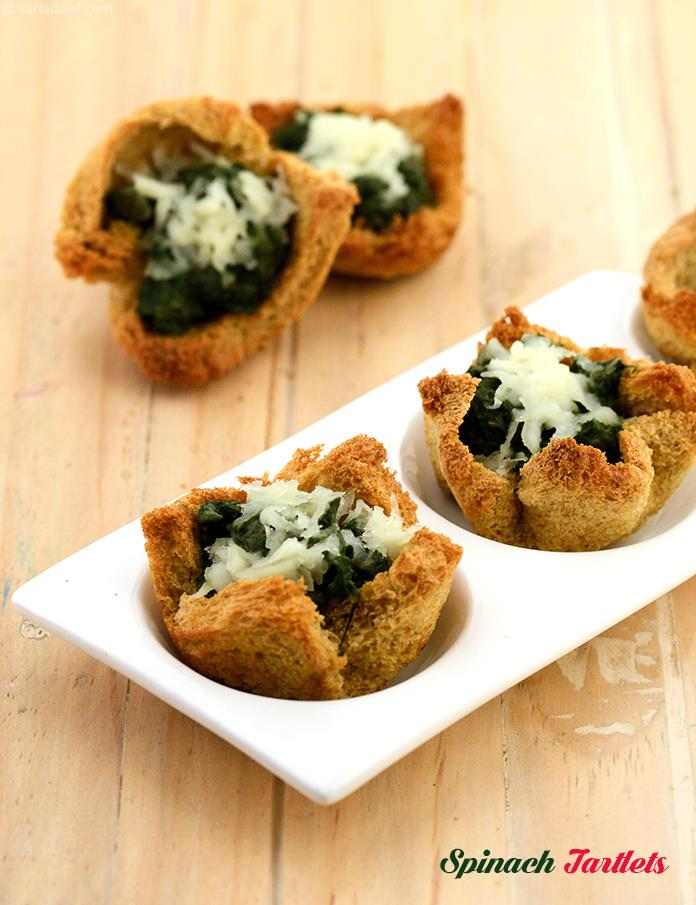 Spinach Tartlets, a simple, less exotic spinach filling for the whole wheat tartlets . The dieter's white sauce keeps the snack healthy.