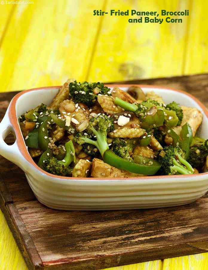 Stir- Fried Paneer, Broccoli and Babycorn, a medley of crunchy veggies, sliced mushrooms and soft paneer, is stir-fried with pungent soy sauce, aromatic til and crunchy crushed peanuts. 