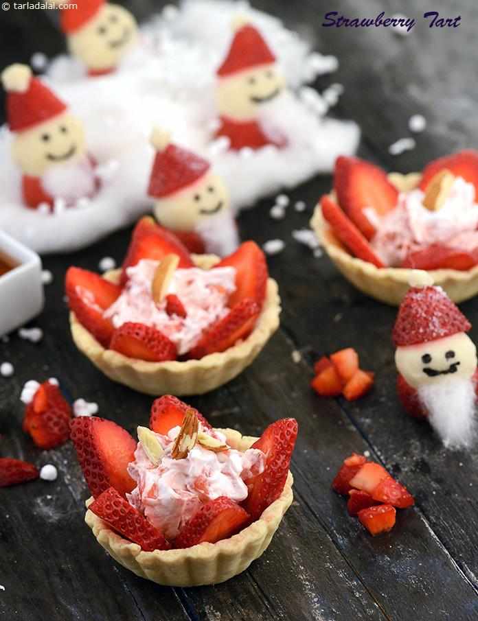 Strawberry tart is a ravishing and luscious tea-time delicacy of dainty pastry tartlets filled with slices of fresh strawberries, honey and whipped cream, and garnished with almonds.