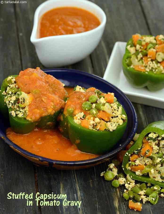 Stuffed Capsicum in Tomato Gravy, capsicum, stuffed with a mixed vegetable and low-fat paneer stuffing, is drowned in a generously-spiced tomato gravy to provide a flavourful boost of fibre and vitamin A.