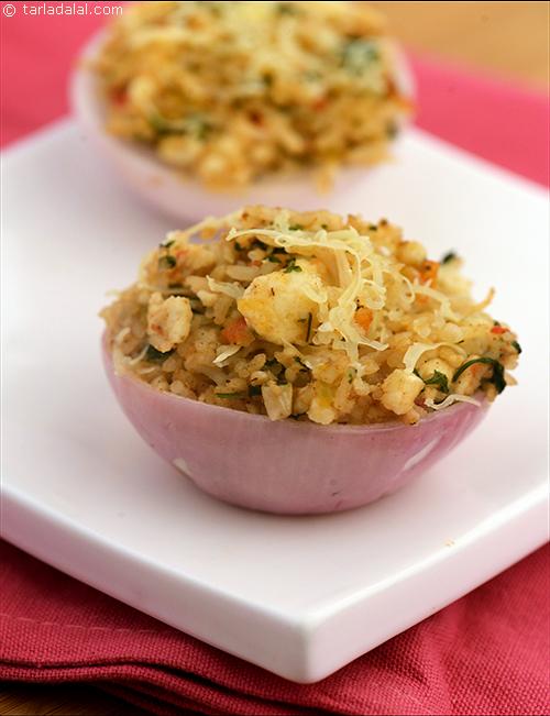 Stuffed Onion Cups, a distinctive kind of baked dish where onion shells are baked with a rich mixture of rice, paneer and Cashewnuts.