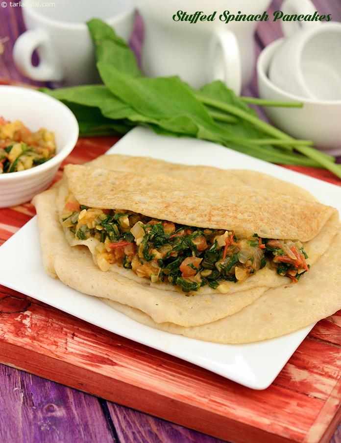 Stuffed Spinach Pancakes, an ideal snack for evenings, these whole wheat flour pancakes ooze out the goodness of spinach, the tanginess of tomatoes and onions, and the richness of mozzarella cheese.