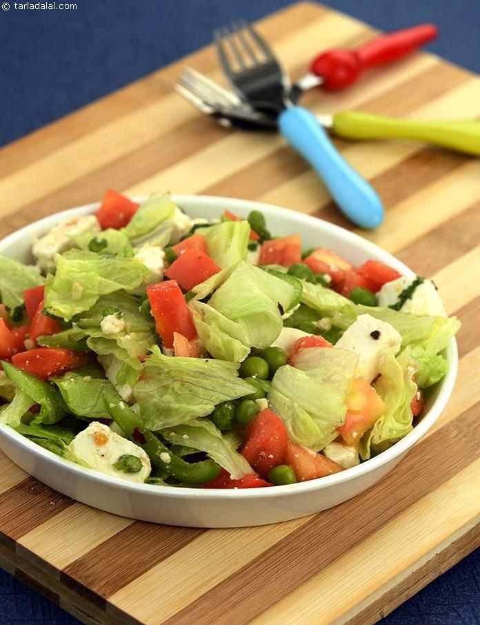 Tangy Lettuce Salad, lots of lettuce with green peas, tomatoes, paneer and capsicum tossed in a tangy spicy dressing.