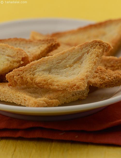 Toasted Triangles, bread brushed with olive oil and crushed garlic baked till crisp, a great accompaniment with soups and dips.