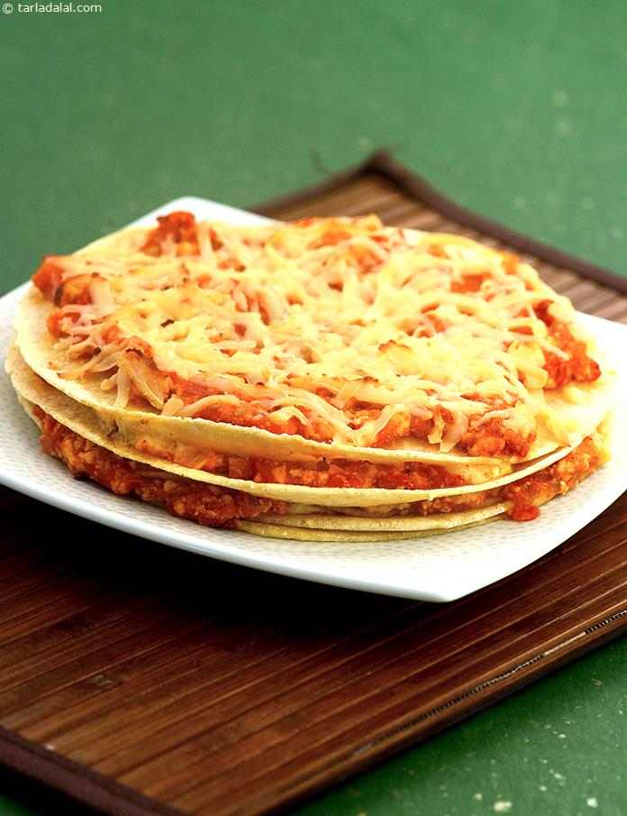 Tortilla Bake, spicy paneer-tomato filling with mustard sauce spread between layers of tortillas, topped with cheese and baked.