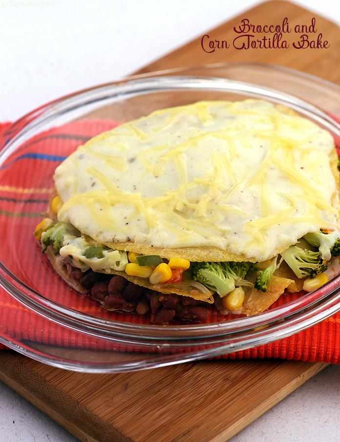 Broccoli and Corn Tortilla Bake, tortillas layered with refried beans , mix vegetables, white sauce and baked topped with a sprinkling of cheese.