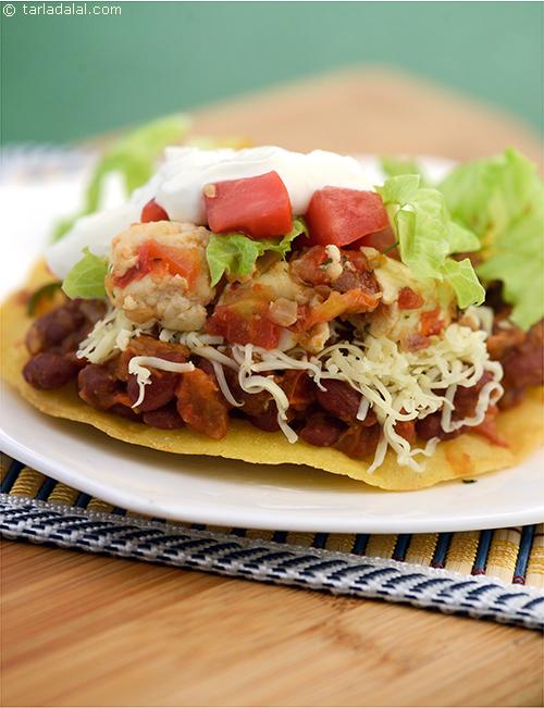 Tostadas, a whole crisp fried tortilla makes the bottom layer on top of which beans and cheese are piled high.