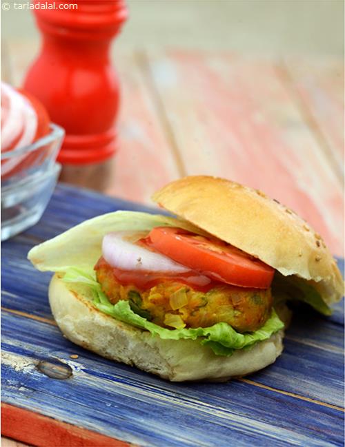 Vegetable Burger made with mixed vegetable patties, crisp lettuce, tomato sauce, and all the works.The perfectly crisp, golden coloured patties are cooked on a non-stick tava with minimal oil.